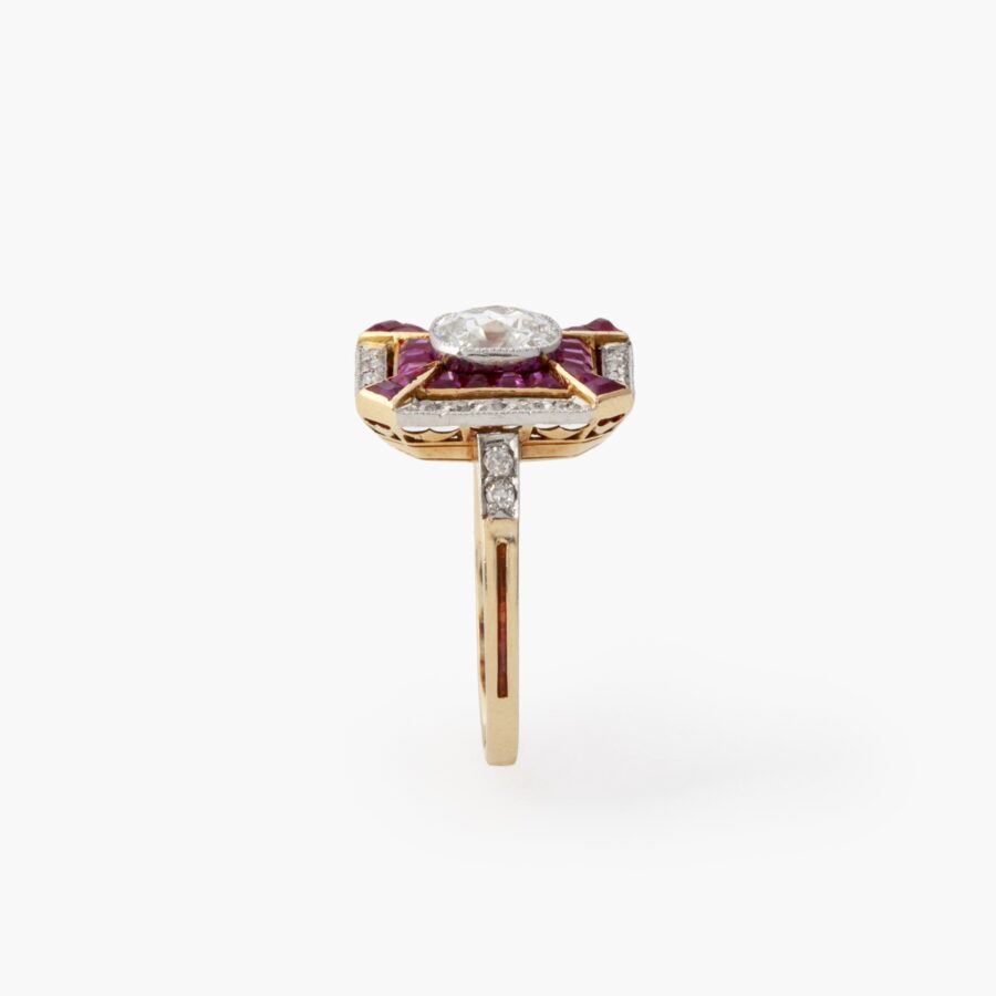 Een achttien karaat rosé goud en platina Art Deco ring bezet met diamanten en robijnen, vervaardigd in Frankrijk, omstreeks 1910.