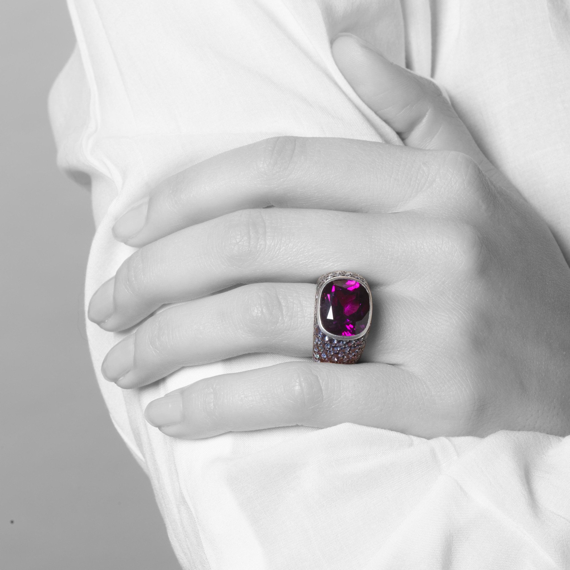 Een achttien karaat witgoud en zilveren ring bezet met een zeldzame paarse granaat en kleine paars-blauwe ‘colour change’ granaten. Hemmerle, München.
