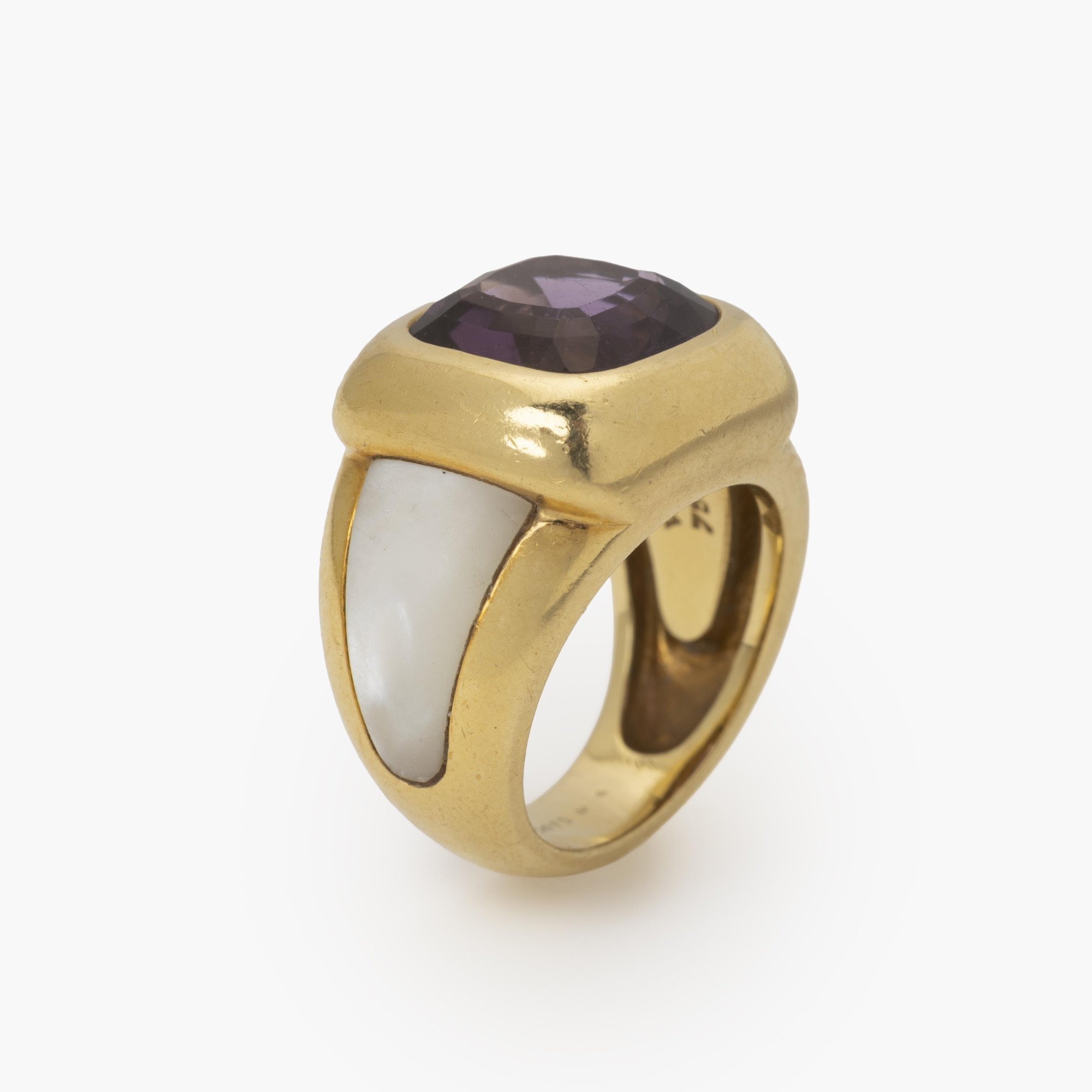 Een achttien karaat geelgouden ring bezet met amethist en wit parelmoer. Gesigneerd Van Cleef & Arpels, vervaardigd in Parijs, omstreeks 1980 en genummerd.